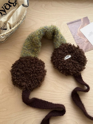 Plush sherpa earmuffs in brown with a textured green and yellow knit headband and ties.