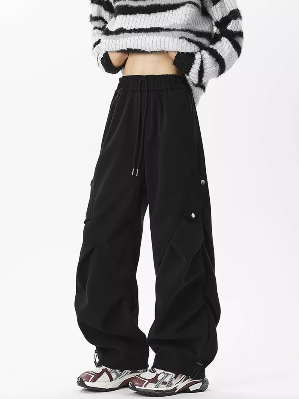 Black comfortable cargo sweatpants with drawstring waist and snap-button cargo pockets.