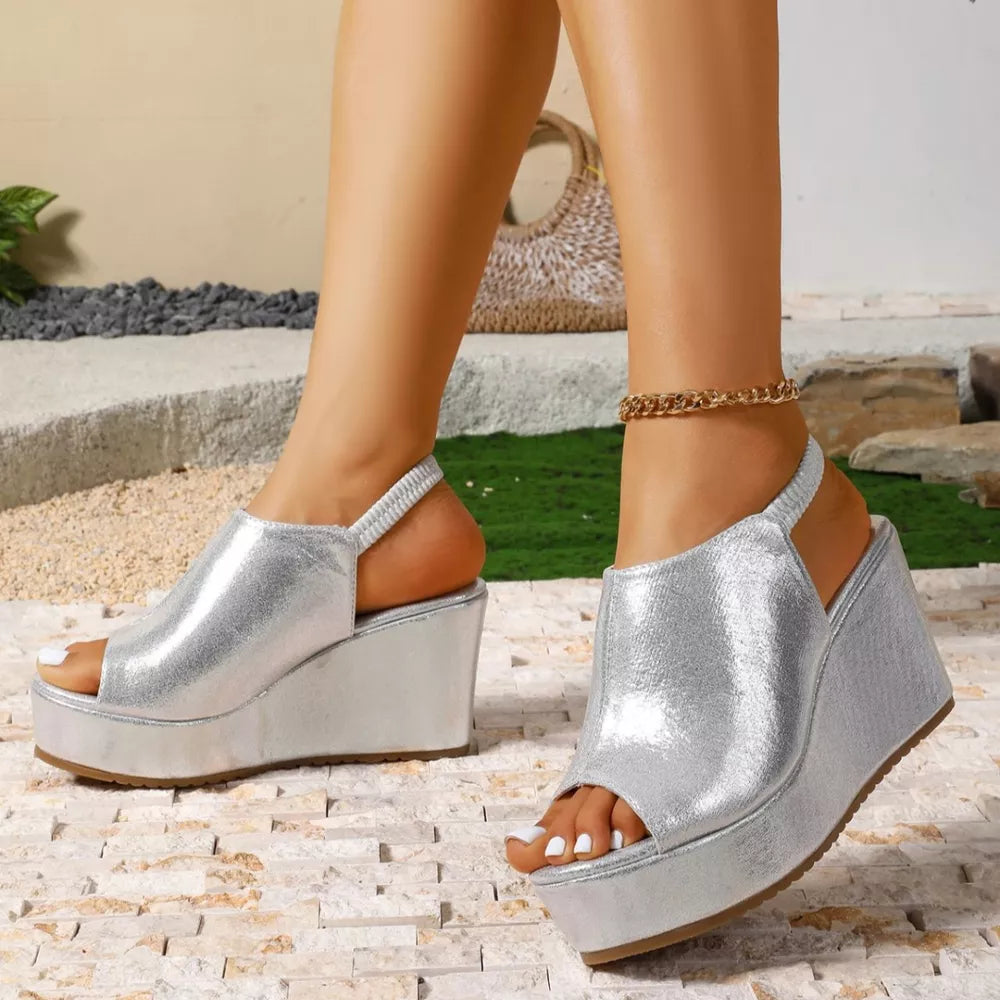 Sleek silver high heel wedge sandals with peep toe and elastic slingback strap.