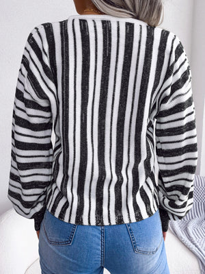 Black and white striped knit cropped pullover sweater with long sleeves.