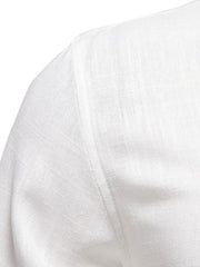 White linen shirt detail showing shoulder seam and textured fabric.