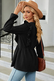 Black textured peplum blouse with ruffle detail and long sleeves