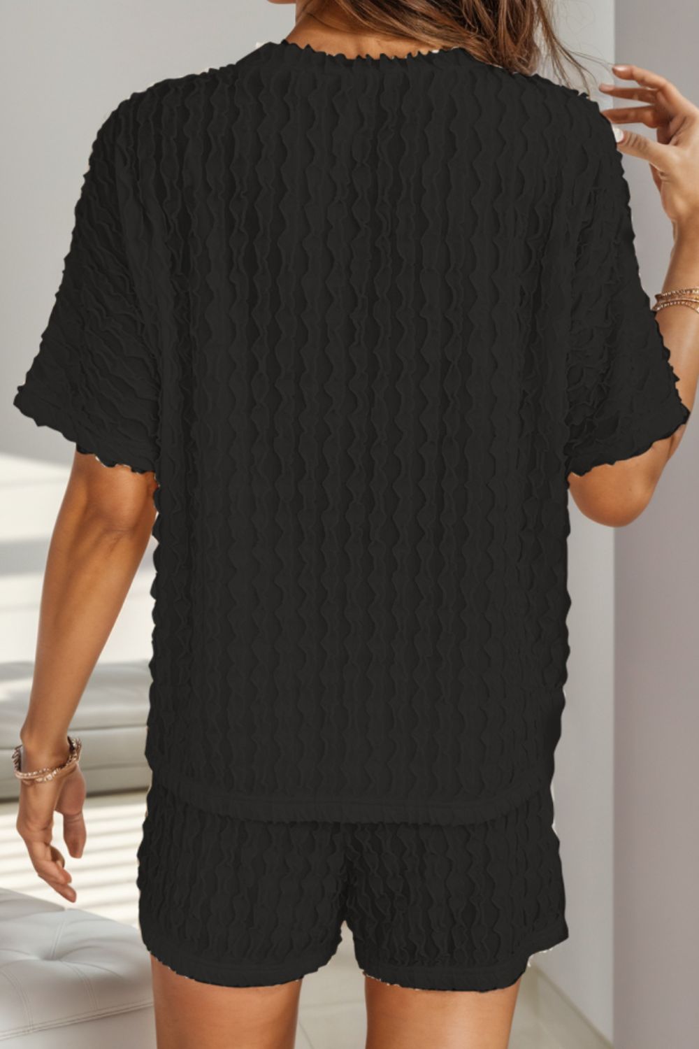 Black textured bouclé tee and drawstring shorts set with short sleeves and lettuce hem detail.