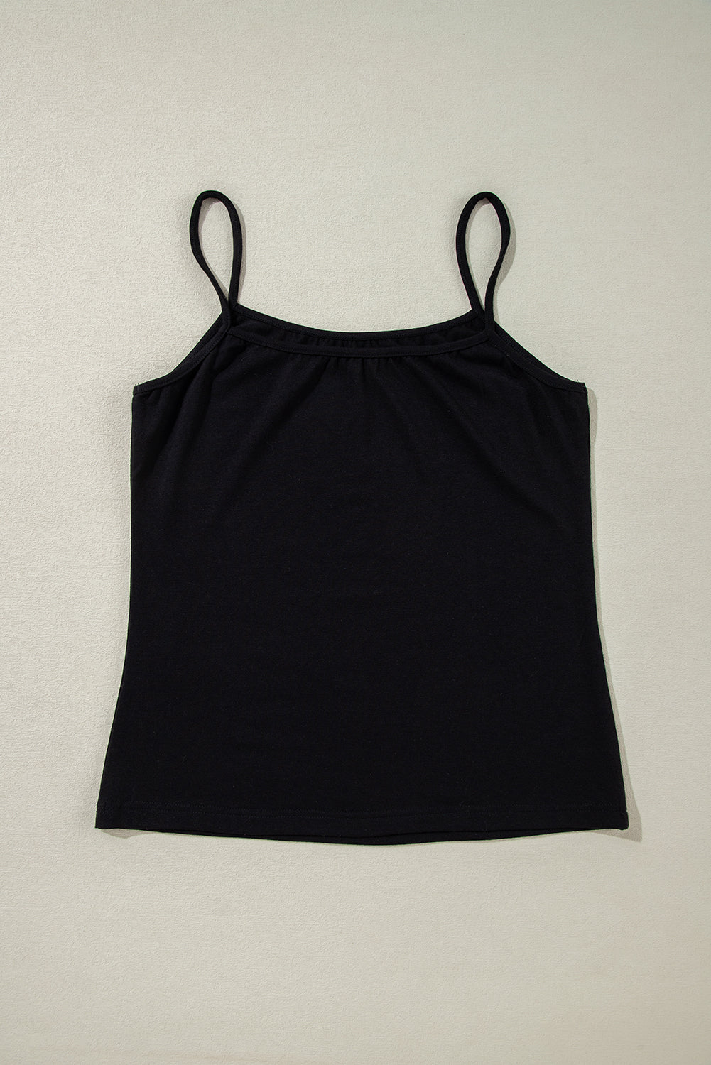 Black cami with thin straps and gathered neckline.
