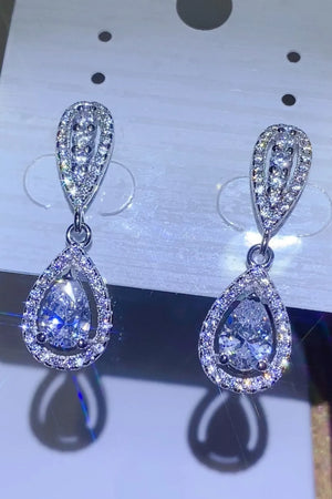 Silver pavé halo moissanite drop earrings with pear-shaped center stones.