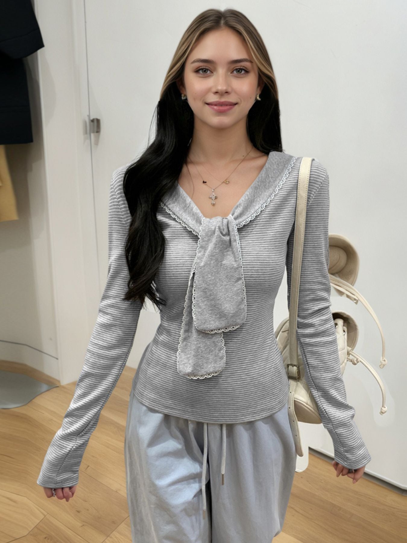 Gray striped ribbed long sleeve top with lace trim and bow detail
