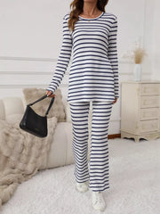 Blue striped knit two-piece set with flared pants and a long sleeve top with side slits.