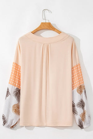 Peach blouse with gathered V-neck and patchwork sleeves featuring polka dots and leaf print.