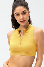 Banana Yellow high-neck zip-front active crop top with a gold zipper detail.
