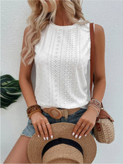 White sleeveless eyelet detail top with a round neckline, styled casually.