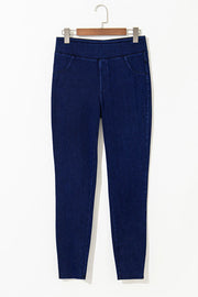 Dark wash denim jeggings with faux pockets and a comfortable elastic waistband.