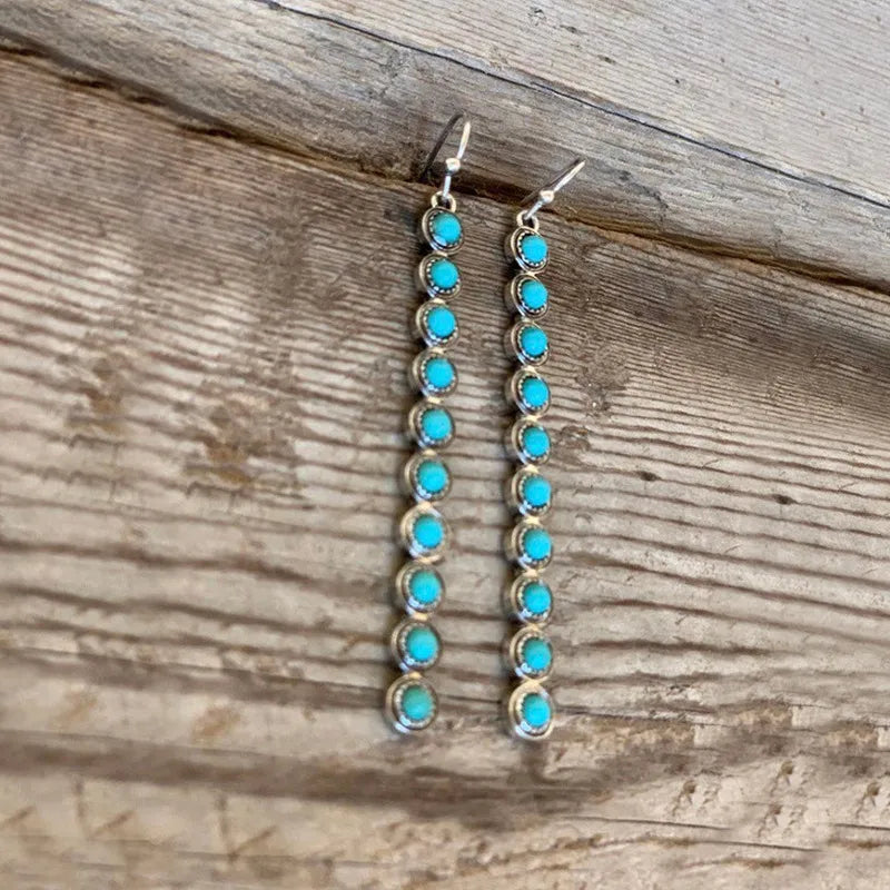Turquoise stone cascade earrings with silver alloy settings.