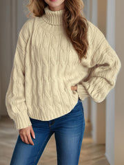 Oversized ivory cable knit turtleneck sweater with ribbed cuffs and hem.