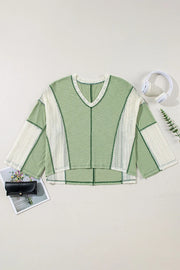 Textured patchwork tunic top in Gum Leaf green with white mesh panels and V-neck.