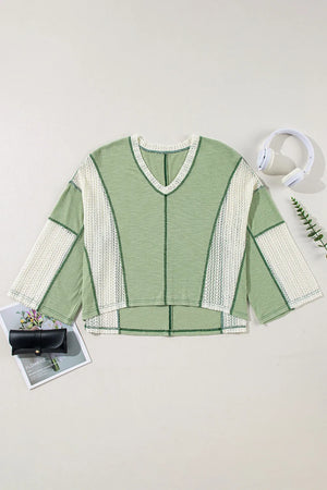 Textured patchwork tunic top in Gum Leaf green with white mesh panels and V-neck.