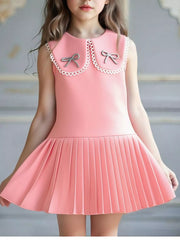 Pink toddler dress with pleated skirt, Peter Pan collar, and two bow details.