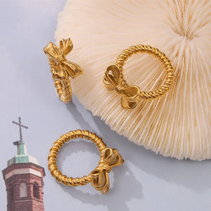 Gold textured bow knot ring with twisted band detail