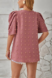 Dusty Pink textured puff-sleeve blouse with pom-pom details and a relaxed fit.