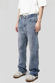 Pocketed denim jeans in medium wash, relaxed fit, casual style.