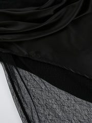 Black midi skirt with sheer lace panel detail and draped satin overlay.