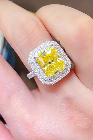 Yellow radiant cut halo ring with canary moissanite center stone and diamond band.
