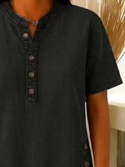 Black denim-inspired short sleeve button blouse with band collar and button detail.