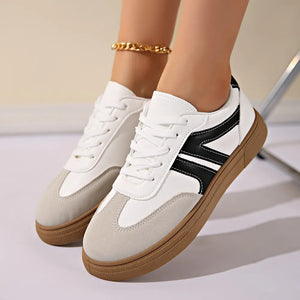 Retro sneakers with white leather, grey suede panels, and black stripe accents.