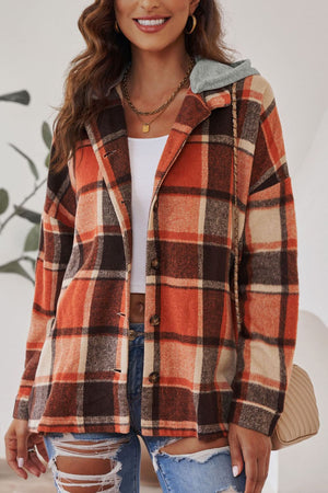 Plaid hooded shacket in orange, tan, and brown with button front and relaxed fit.