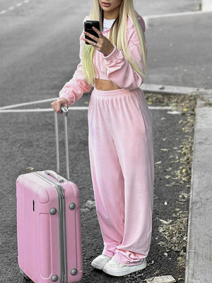 Pink cropped zip hoodie and wide leg sweatpants set with elastic waistband.