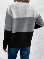 Colorblock boatneck knit sweater in gray and black acrylic with horizontal stripe pattern.