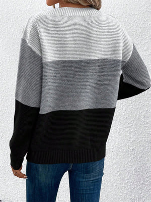 Colorblock boatneck knit sweater in gray and black acrylic with horizontal stripe pattern.