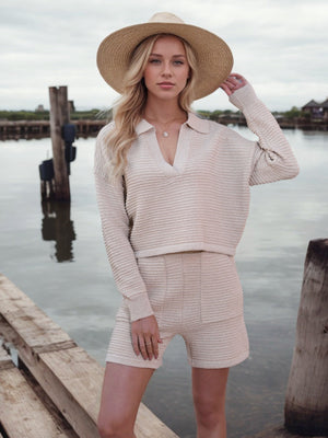 Textured knit polo sweater and shorts set in light beige, styled with a straw hat.