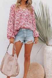 Floral puff sleeve v-neck blouse in blush pink with a casual, flowy fit.