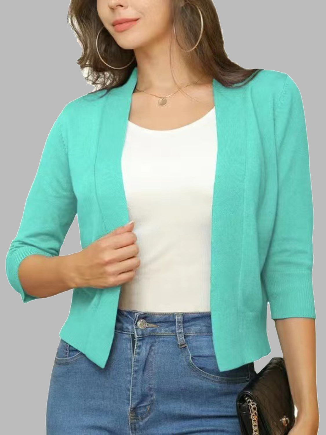 Teal open-front cropped cardigan with elbow sleeves and a relaxed fit.