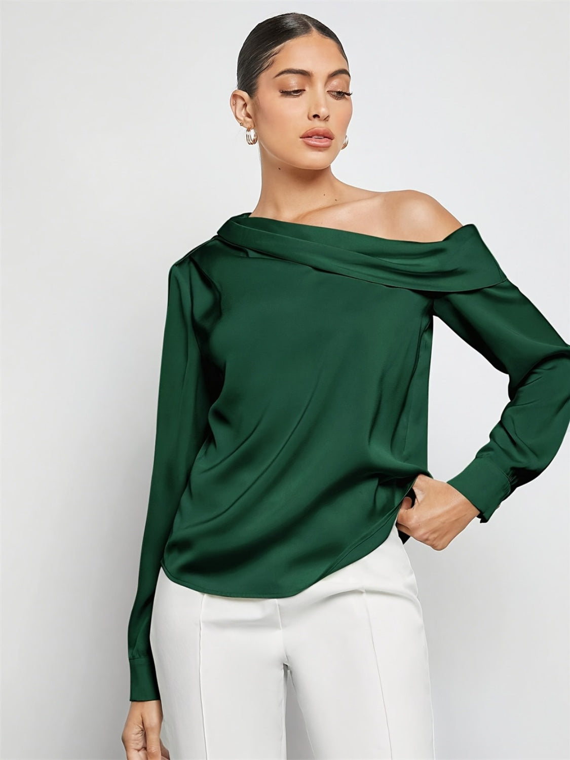 Dark green silk-effect blouse with asymmetric neckline and long sleeves.