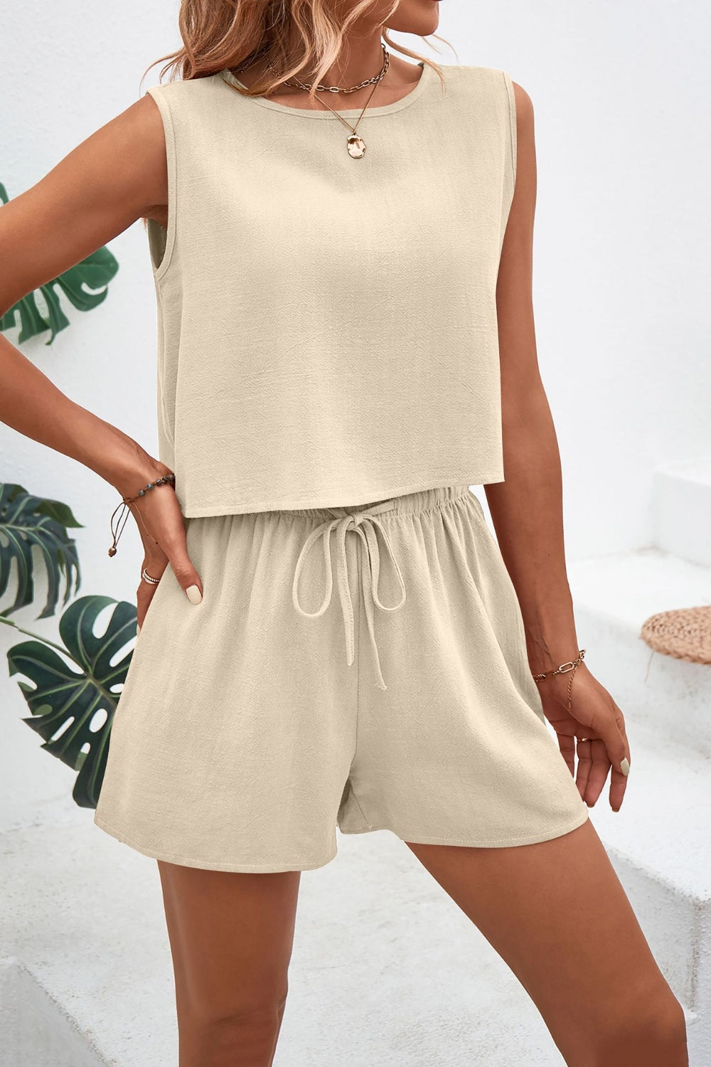 Beige textured crop top and shorts set with adjustable drawstring shorts.