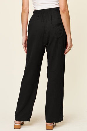 Black textured gauze relaxed drawstring trousers with a back pocket detail