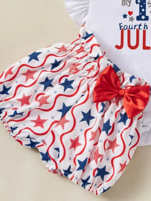 Baby outfit with red, white, and blue star print bloomers and a red bow.