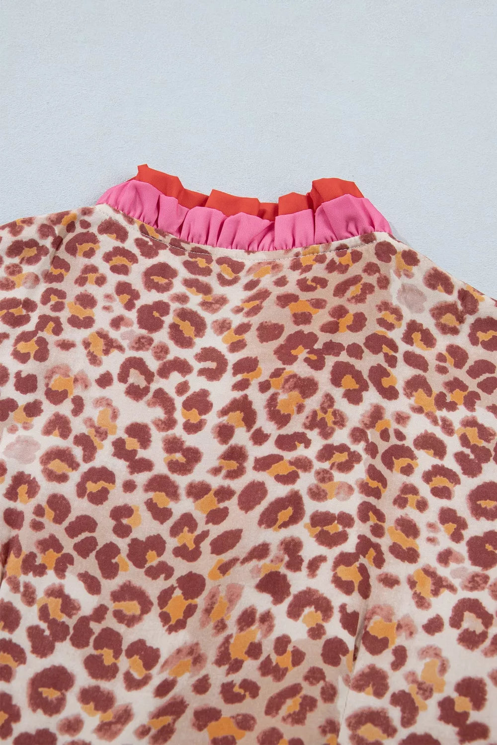 Leopard print dress with ruffled pink and orange V-neck detail