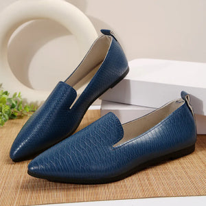 Navy textured pointed-toe slip-on loafers with a subtle snake print detail.