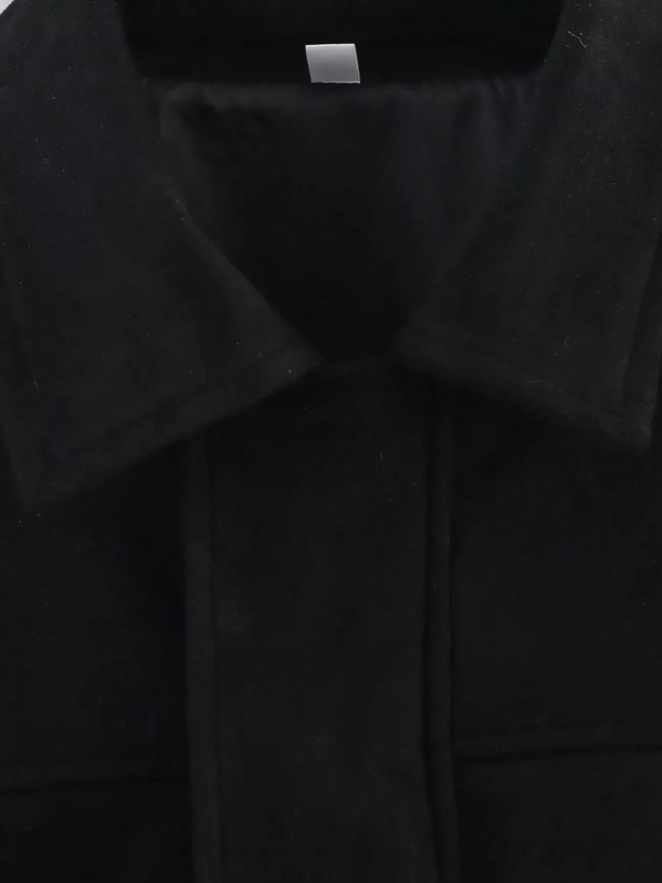 Black oversized zip-up jacket with a collared neckline and visible seams.