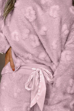 Textured lounge set in blush pink plush with heart pattern and satin tie waist.