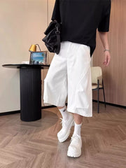 Men's white relaxed fit cropped cargo pants with wide leg and unique seam details.
