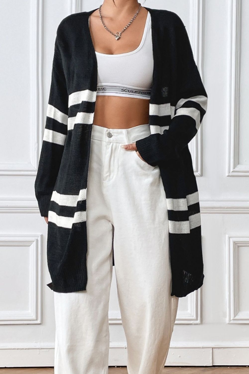 Oversized black and white stripe knit cardigan with open front and long sleeves.