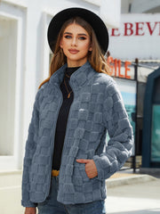 Textured grid zip-up jacket in grey with a mock neck and zip closure.