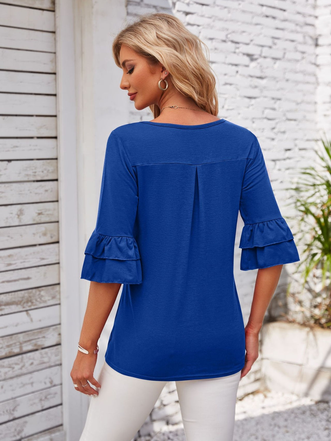Royal blue blouse with ruffled sleeves and square neckline.