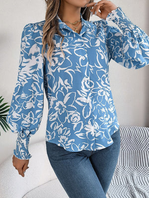 Light blue floral print blouse with shirred cuffs and button front