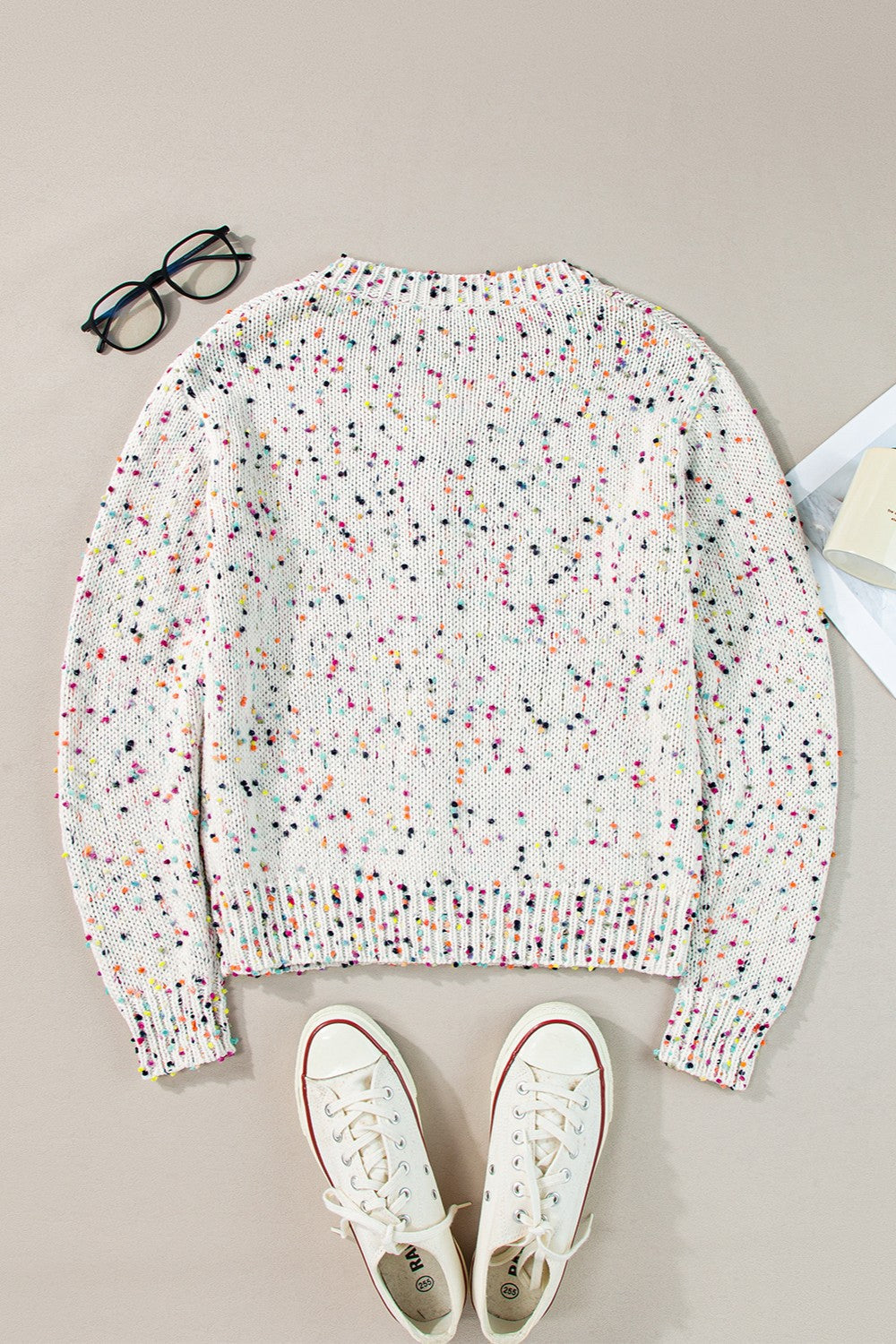 White confetti knit button-up cardigan with a crew neck and long sleeves.