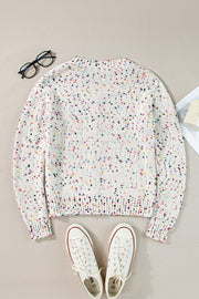 White confetti knit button-up cardigan with a crew neck and long sleeves.
