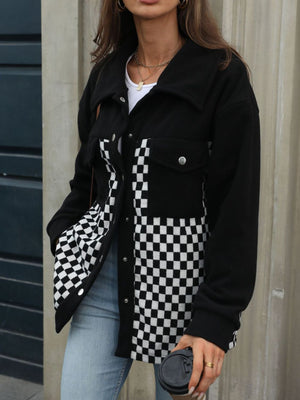 Black button-up jacket with checkerboard panels and chest pockets.